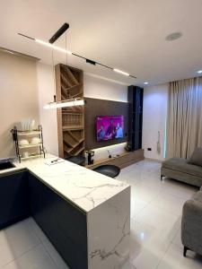 a kitchen and living room with a counter and a couch at Cosmos in Lagos