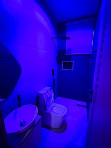 a bathroom with a white toilet and a sink at Cosmos in Lagos