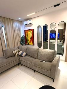 a living room with a couch and some mirrors at Cosmos in Lagos +10 photos