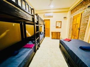 a bedroom with two bunk beds in a room at OM Inn in Trincomalee