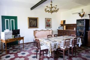 a dining room with a table and a desk at B&B Anima Selvaggia Ranch in Castellero