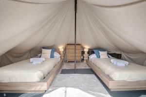 a bedroom with two beds in a tent at Agriturismo Le Pale in Bogliasco +54 photos