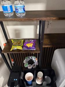 a small shelf with a table with cups on it at Signature Suite in Orlando