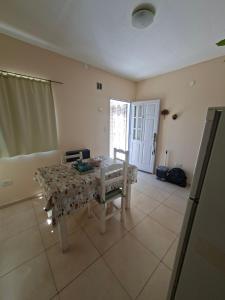 a living room with a table and a chair at Departamentos Roxy in Viedma