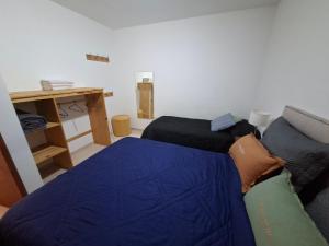 a bedroom with a bed and a desk in it at Departamentos Roxy in Viedma