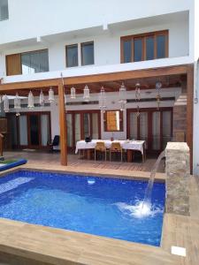 a villa with a swimming pool and a dining area at Surfers Paradise - Casa Caro in Punta Negra +22 photos