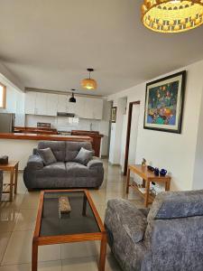 a living room with two couches and a table at Surfers Paradise - Casa Caro in Punta Negra
