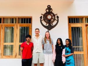 a family posing for a picture in front of a building at Anchorage Apartment in Kurunegala