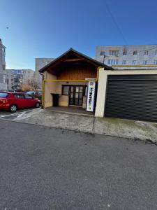 a building with two garage doors in a parking lot at Azur House in Cluj-Napoca