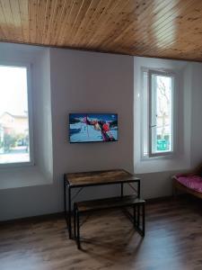 a living room with a table and two windows at MTB b&b in Alfonsine