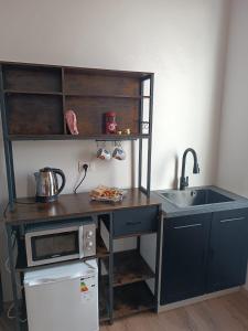 a small kitchen with a sink and a microwave at MTB b&b in Alfonsine +15 photos