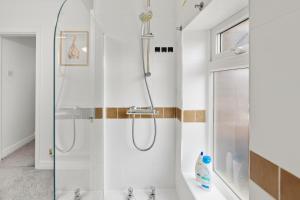 a bathroom with a shower with a glass door at Spacious 1-Bed - Town Centre - Free Parking in Warrington