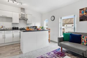 a kitchen and a living room with a couch at Spacious 1-Bed - Town Centre - Free Parking in Warrington