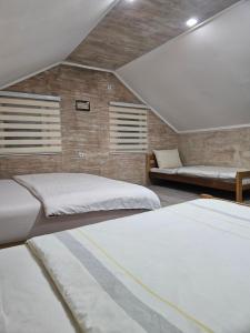 two beds in a room with two beds sidx sidx sidx at Rooms Stefan 2 in Subotica