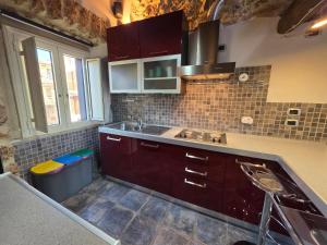 a kitchen with brown cabinets and a sink at Loft Naevio in Ferentino +11 photos