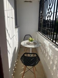 a small table and two chairs on a balcony at Zuribreezhomes in Bamburi