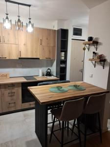 a kitchen with a wooden table and some chairs at Apartman Mihajlo in Divčibare