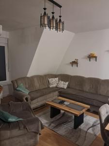a living room with two couches and a coffee table at Apartman Mihajlo in Divčibare