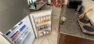 a small refrigerator with its door open in a kitchen at Casa Pyramids View in Cairo +62 photos