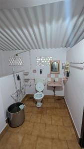 a bathroom with a toilet and a sink at Le Stories Heritage Home in Kottayam