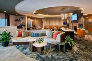 a hotel lobby with a couch and tables at SpringHill Suites by Marriott Albany Latham-Colonie in Albany