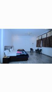 a bedroom with a bed with a blue light at Shree Hanumantam homestay in Ayodhya +14 photos