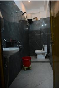 a bathroom with a sink and a toilet at Shree Hanumantam homestay in Ayodhya