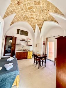 a bedroom with a bed and a table in a room at Corte della Luce in Ugento