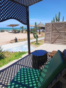 a patio with a couch and a view of the beach at maison d'hôtes la merveille in Dakhla +20 photos