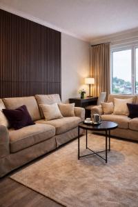 a living room with a couch and a table at Stilla Hem 2 in Tranemo