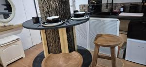 a table with cups and saucers on it in a kitchen at The Orchard's Nook Treehouse in Cottenham +34 photos
