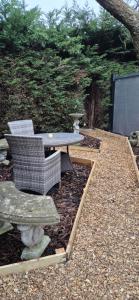 a table and two chairs and a table and a table and chairs at The Orchard's Nook Treehouse in Cottenham
