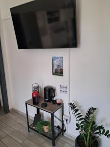 a tv hanging on a wall with a coffee table at L'antica torre in Tuscania