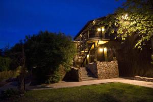 a house with stairs leading up to it at night at Arciau Juros in Palanga