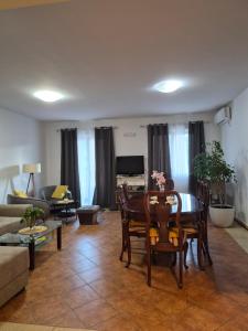 a living room with a table and chairs at Stan Duo in Herceg-Novi