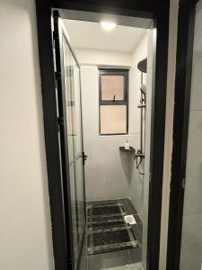a glass door leading to a bathroom with a walk in shower at joy in Nairobi
