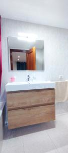 a bathroom with a sink and a mirror at Piso 3 habitaciones en Pescadores, 6 in Peniscola +22 photos