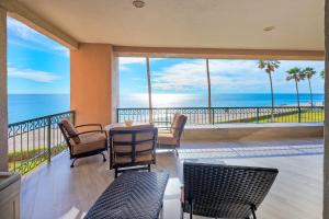 a dining room with a table and chairs and the ocean at Beachfront Oasis at Sonoran Spa E201 in Puerto Peñasco