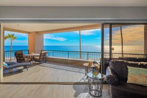 a living room with a view of the ocean at Beachfront Oasis at Sonoran Spa E201 in Puerto Peñasco