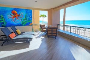 a living room with an octopus painting on the wall at Beachfront Oasis at Sonoran Spa E201 in Puerto Peñasco +47 photos