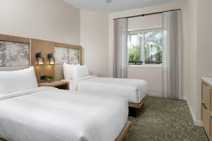 a hotel room with two beds and a window at Marriott's Imperial Palms Villas in Orlando +20 photos