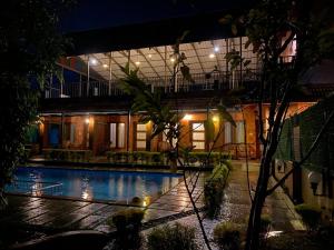 a house with a swimming pool at night at Ponyo Stays in Cochin