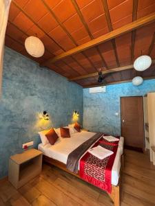 a bedroom with a large bed in a room at Ponyo Stays in Cochin