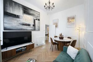 a living room with a large television and a table at The Barony Fox in Edinburgh