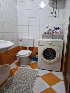 a bathroom with a toilet and a washing machine at Stan Duo in Herceg-Novi +39 photos