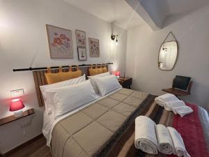 a bedroom with a large bed with towels on it at postAielli - Arte, Natura e Relax in Aielli