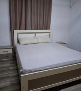 a bed in a bedroom with a white bed frame at Authentic South in Mahébourg