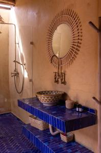 a bathroom with a sink and a mirror at Muma Lodge in Bouihat +65 photos