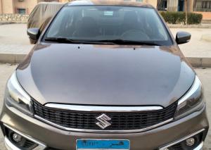 a silver car parked in a parking lot at private car in cairo in Asyut