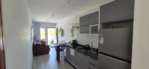 a kitchen with a sink and a counter top at Casa42 aconchego perto de Florianópolis in Palhoça
